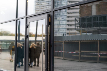 Naklejka premium Outside solid glass door with building exterior