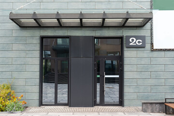 Naklejka premium Outside solid glass door with building exterior