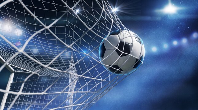 A professional soccer ball hitting the back of the net in a brightly lit stadium at night, symbolizing a winning goal during a major sports championship match.