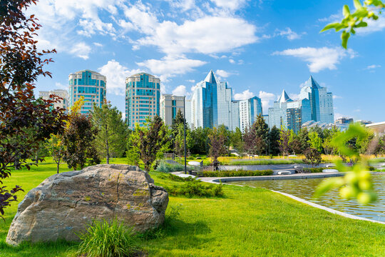 Modern city park with lush greenery and contemporary skyline in Almaty Kazakhstan