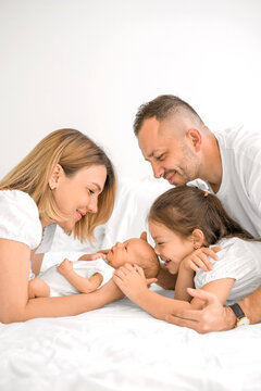 A newborn boy surrounded by his parents and older sister. Love and nurturing in harmony.