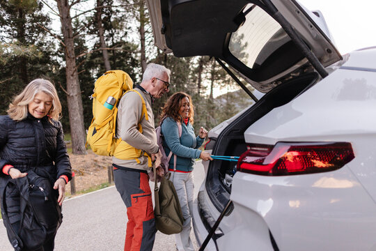 Mature friends preparing for a outdoor hiking adventure