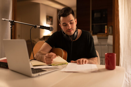 Young man creating music in home studio