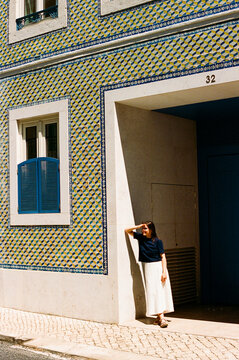 Woman standing by tiled building lisbon travel film photo