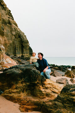 Travel Adventure Dad and Toddler on Rocky Beach