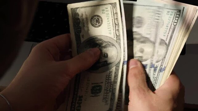 Finance man unrecognizable counting dollars showing personal investments and cash savings concept in 4K Ultra HD footage.