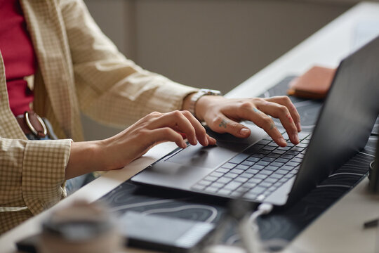 Close up of woman typing on laptop at desk, managing online work and digital communication. Ideal for office work, business, productivity marketing