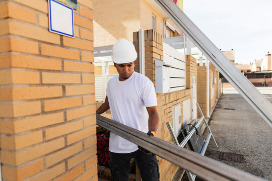 Repairman carrying building materials for home renovation