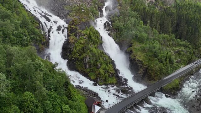 Aerial drone horizontal pan right flyover of Latefossen with highway, Norway