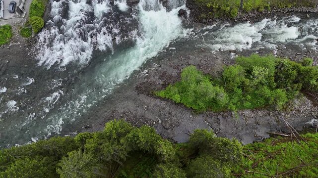 Aerial drone pan up of Latefossen with highway, Norway