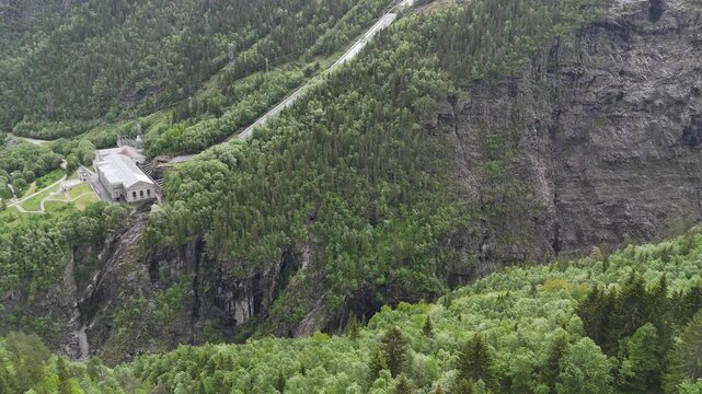 Aerial drone of Industrial Workers Museum, trees, mountains and waterfalls, Norway