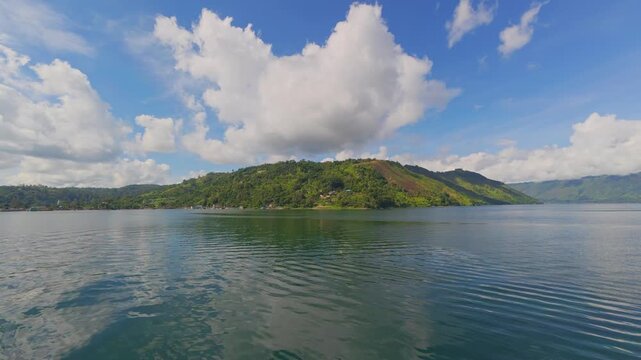 Peaceful Morning View Over Lake Toba with Mountains and Calm Water