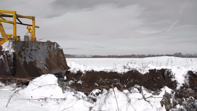 snowplow clearing open field covered in snow productive cold side view construction winter maintenance natural light clean background copy space editorial educational visual story design.