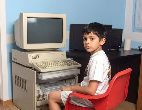 Child Sitting in Front of Vintage Computer