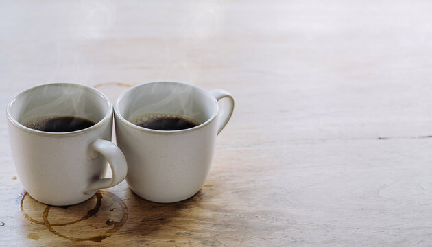 Two Coffee Cups Together on Wooden Table