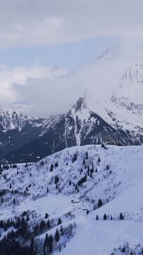 A panoramic winter view of the snowy Alps in the Sallanches, Passy, Mont Blanc, Mont Joly, and Megeve area of Haute-Savoie, France. The video clip shows expansive snow-covered slopes dotted with