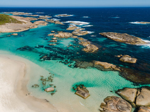 Aerial view of the turquoise waters and granite boulders of Greens Pool, with white sand beach and deep blue ocean in Denmark, Western Australia, Australia.