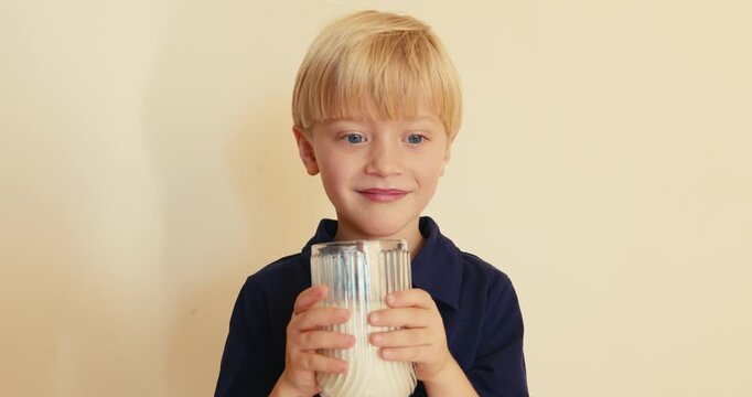 Adorable little boy with missing tooth drinking milk
