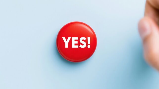 Hand pressing red button displaying YES., symbolizing affirmation, approval, decision, and positive choice