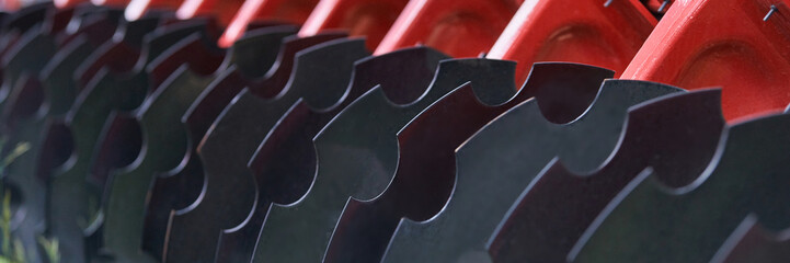 Agricultural Disc Harrow Blades Aligned On Red Frame In Close Up Detail Showing Curved Steel Discs...