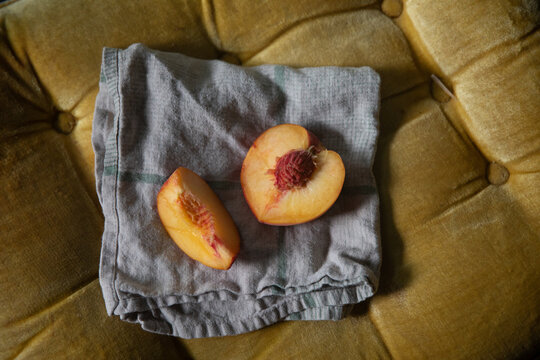 Peach cut in two pieces on grey napkin