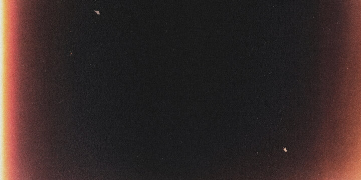 Film frame with light leaks and grain dark background with reddish orange edges leak analog