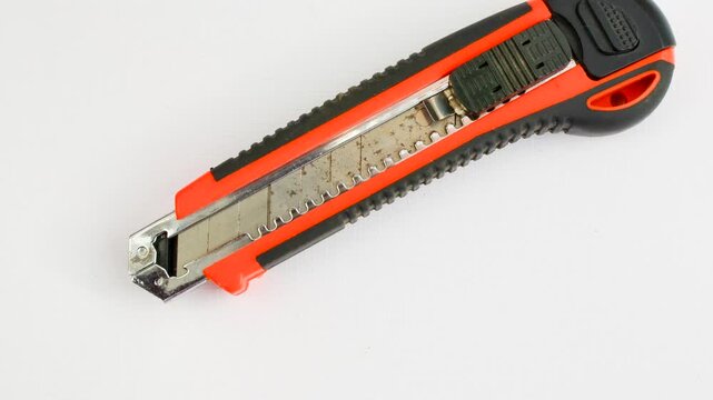 Sharp utility knife on a clear surface, ready for precise cuts for creative projects. Close-up of a stylus on a light background, an essential tool for detailed work.