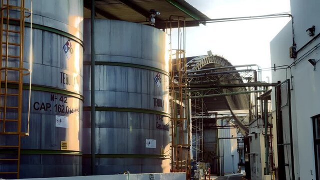Massive industrial storage tanks and processing pipelines at Hacienda Sauza highlight the scale of tequila production within one of Mexicos most recognized distilleries.