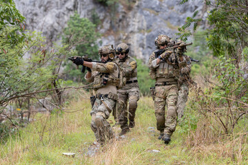 Fototapeta premium Military participate in a patrol in forrest terrain