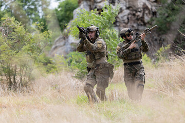 Fototapeta premium Military participate in a patrol in forrest terrain