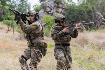 Fototapeta premium Military participate in a patrol in forrest terrain