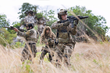Fototapeta premium Military participate in a patrol in forrest terrain
