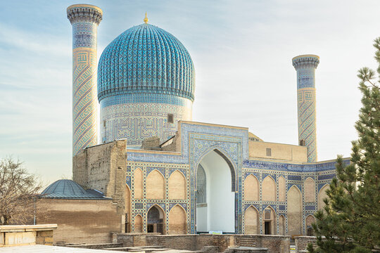 Gur-e-Amir mausoleum with its iconic turquoise ribbed dome and twin minarets in Samarkand, Uzbekistan. Ideal for travel publications, history textbooks, and cultural tourism promotion.