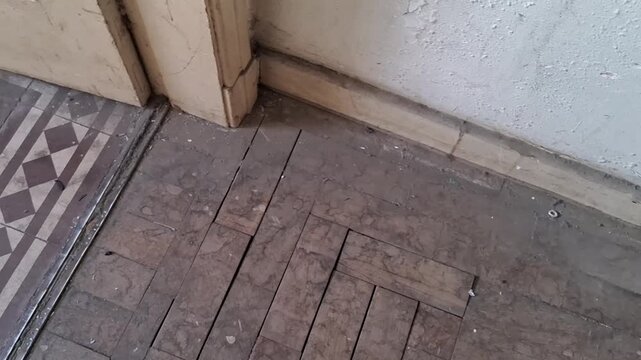 Aged herringbone wooden floorboards inside a rustic vintage video animation