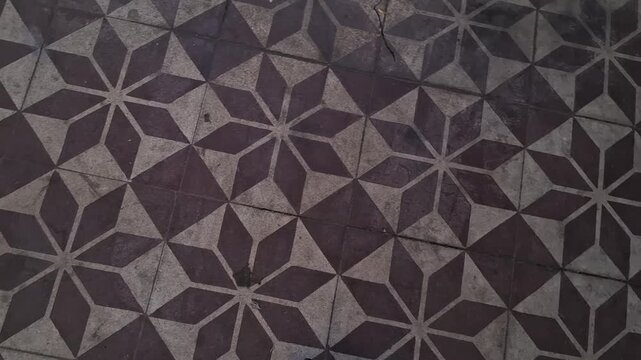 Geometric star pattern floor tiles captured in rhythmic motion video footage