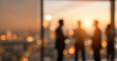 Naklejka na ściany i meble Silhouettes of business people engaged in conversation against a backdrop of a city skyline at sunset, creating a warm, professional atmosphere.