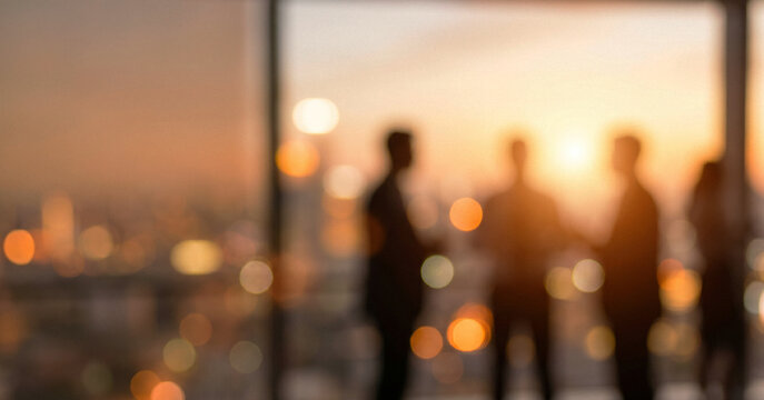 Silhouettes of business people engaged in conversation against a backdrop of a city skyline at sunset, creating a warm, professional atmosphere.