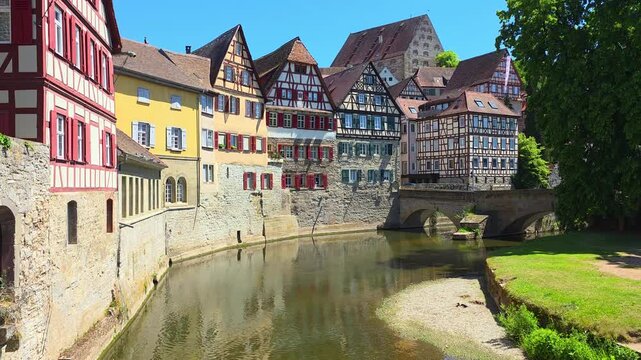 Traditional riverside half timbered  houses in the Old Town of Schwabisch Hall, Germany. Slow upward panning motion.