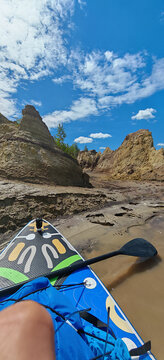 A photo of a bright SUP board against a beautiful background. Paddle board.