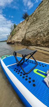 A photo of a bright SUP board against a beautiful background. Paddle board.