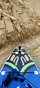 A photo of a bright SUP board against a beautiful background. Paddle board.