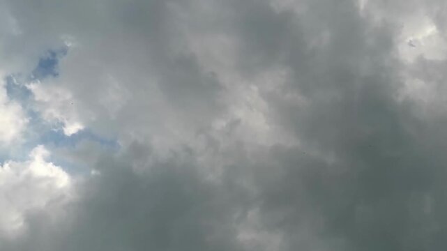 Dramatic Dark Storm Clouds Gathering in Sky with Glimmers of Blue Sky