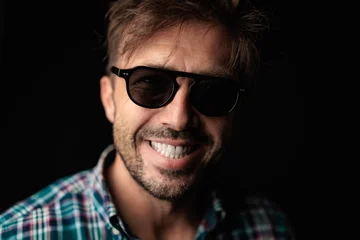 Cheerful man smiling with casual checkered shirt and sunglasses © Viorel Sima