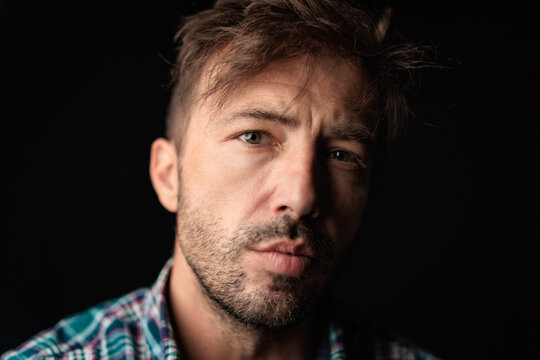 Handsome casual man in plaid shirt looking forward