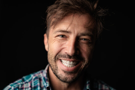 Happy man in checkered shirt smiling