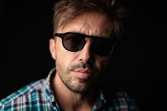 Serious man with sunglasses looking forward