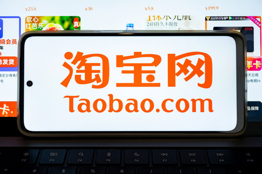 Smartphone displaying taobao.Com logo for online shopping in china