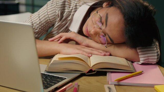 Sleeping tired Latina American woman napping at home overworked student businesswoman exhausted teen girl resting on table during boring online studying laptop weary sleepy sleep close eyes at kitchen