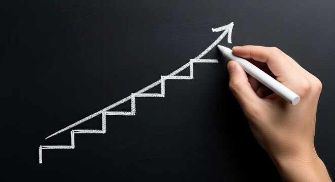 Hand drawing an upward staircase graph on a blackboard with white chalk