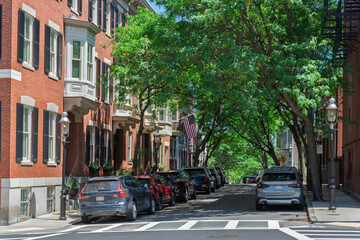 Obraz premium Charming tree lined brick townhouse street in Charlestown Boston 